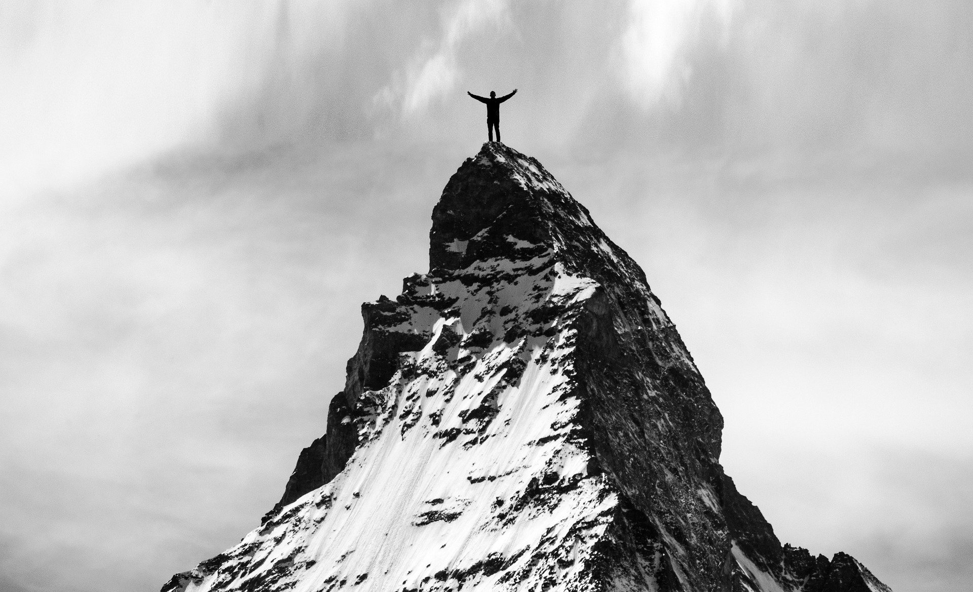 A mountian climber reaches his goal.