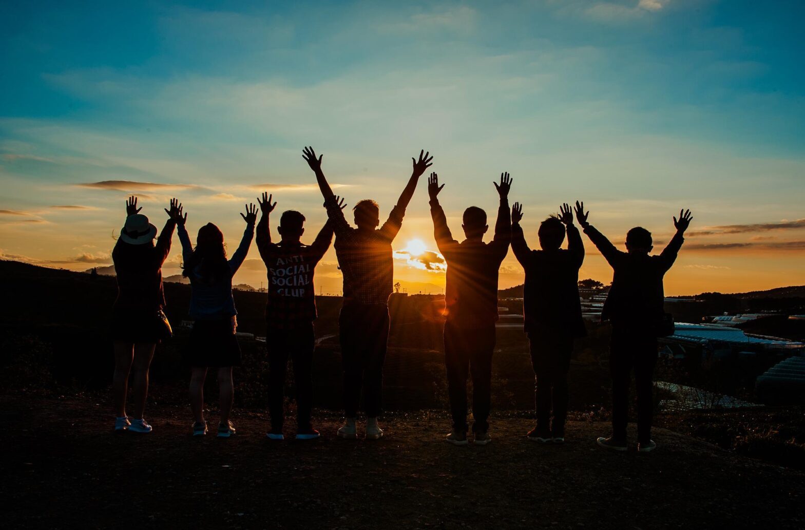 A group of teens greet the sunrise.